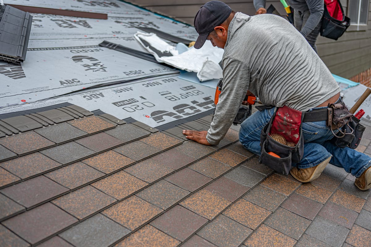 High Quality Roofing professional installing asphalt shingles on a Halifax-area roof